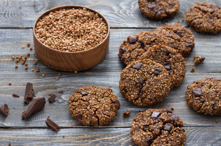 Healthy gluten-free buckwheat cookies with chocolate on a wooden tableの写真素材