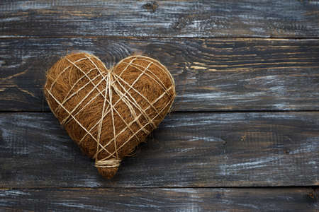 Straw heart on wooden background, rustic style, top view, spaceの写真素材