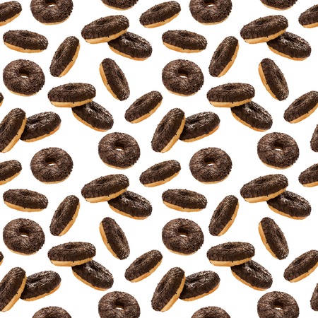 Donuts in chocolate glazed with chocolate chips isolated on the white background, seamless pattern, top view, flat layの写真素材