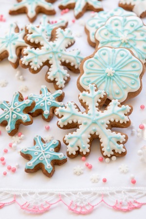 Christmas decoration with cookies in the shape of snowflakes and stars on a white backgroundの写真素材