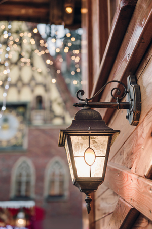 Christmas lantern. Festive illumination on a wooden house.の写真素材