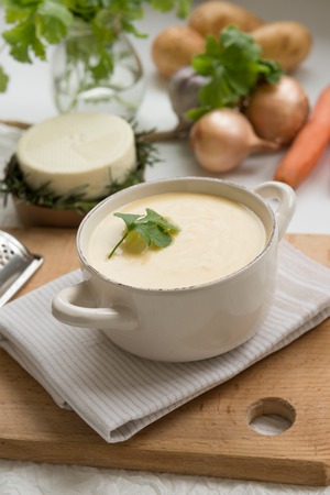 Cheese soup with yellow and white cheese, cream, onions and potatoes. Decorated with green coriander. Healthy Vegetarian Foodの写真素材