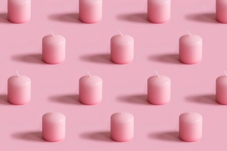 Christmas composition with Christmas a pink candles on pink background. Happy holidays greeting card minimalism conceptの写真素材