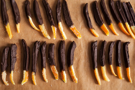 Candied orange peel in chocolate or sugar is a favorite Christmas treat for children and adults. Image of home made candied orange peel some pieces dipped in chocolate. Top viewの写真素材