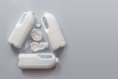 Used white plastic packaging for food on a gray background. The concept of protecting the...