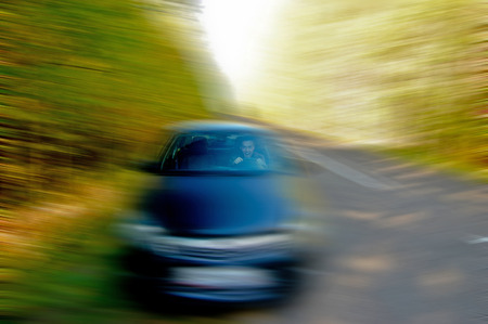 man riding in the car at high speedの写真素材