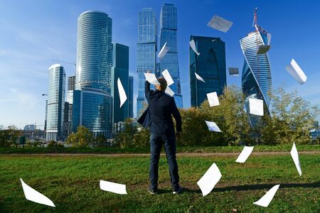 man throws paper sheetsの写真素材