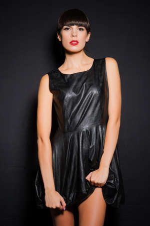 the woman in a black dress on a black backgroundの写真素材