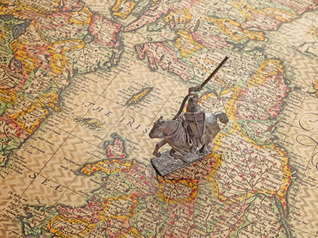 model of medieval knight on an age-old mapの写真素材