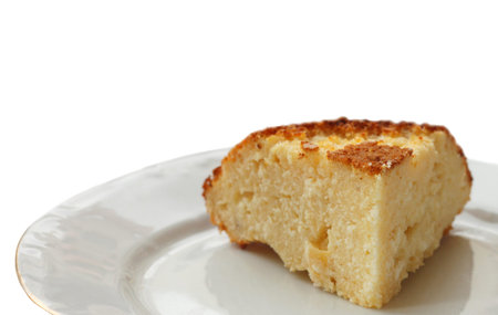 piece of the curd baked pudding on a dish on a white background 