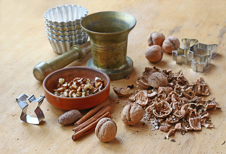 Split nuts, mortar and forms for a thin captain on a wooden tableの写真素材