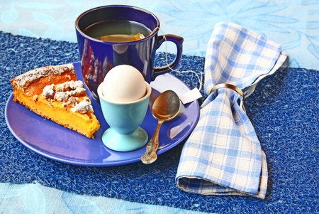 Dietary breakfast with green tea, pumpkin pie and eggの写真素材