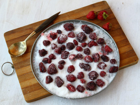 Cooking of strawberries in sugar - a dry strawberry jam or candied strawberryの写真素材