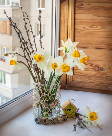 Easter bouquet of daffodils and willow twigs on the balconyの写真素材