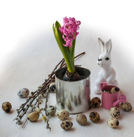 Easter still life with  hyacinth and willow twigs next to the rabbit figurineの写真素材