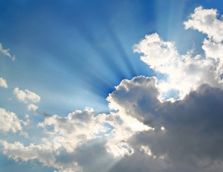 Sun shining through the clouds summer day 
