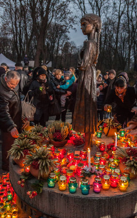 UKRAINE, KIEV - NOVEMBER 22: Monument to Victims of Famine devoted to genocide victims of the Ukrainian people on November 22, 2014, in Kiev, Ukraine. People with candle in hands.のeditorial素材