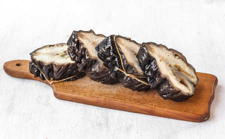 Pieces of smoked sturgeon on a cutting board