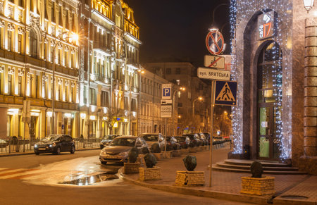 KIEV, UKRAINE - MARCH, 23, 2017: Night multi-colored illumination of the old beautiful buildings of the Ilyinska street on Podol in Kiev, Ukraine, Kiev, Ukraineのeditorial素材