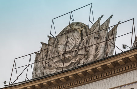 KIEV, UKRAINE-26 FEBRUARY 2017: Collapsing coat of arms of the USSR, which consisted of Ukraine, on the facade of a house in Kievのeditorial素材