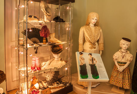KIEV, UKRAINE - AUG 19, 2017: Ladies accessories, shoes, fans on the background of a dummy home dress of the early 20th century in Kiev, Ukraine.のeditorial素材