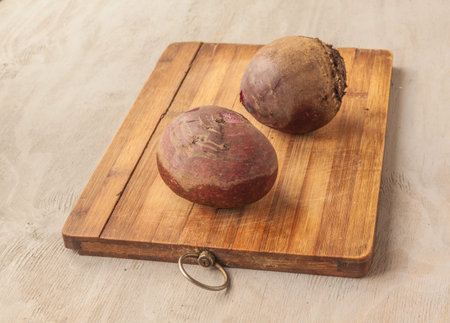 Two boiled beets on kitchen table. Vegan cuisineの写真素材