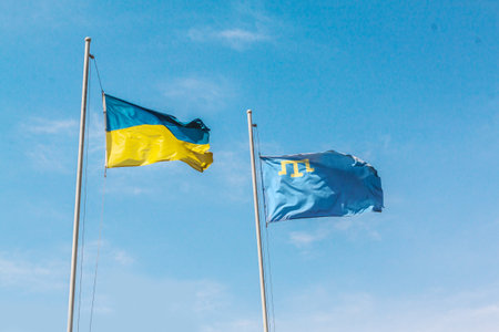 Flying flag of Ukraine and Crimea in the blue sky. State symbols of Ukraineの写真素材
