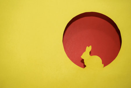 Yellow silhouette of Easter bunny in round windowの写真素材