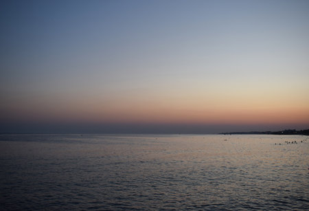 Tranquil Ocean Sunset with Distant Horizonの写真素材