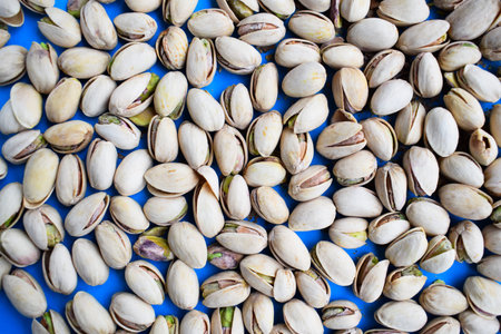 Pistachios Scattered on Blue Background