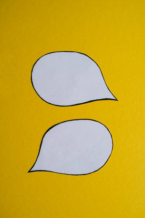 Two Blank Speech Bubbles on Yellow Backgroundの写真素材