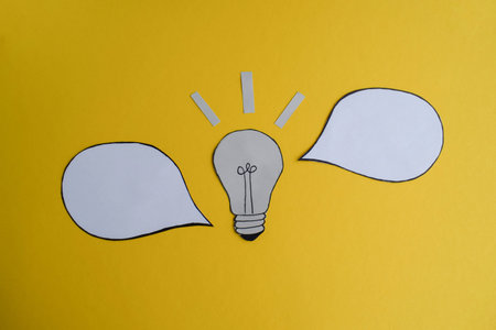 Light Bulb Idea with Speech Bubbles on Yellow
