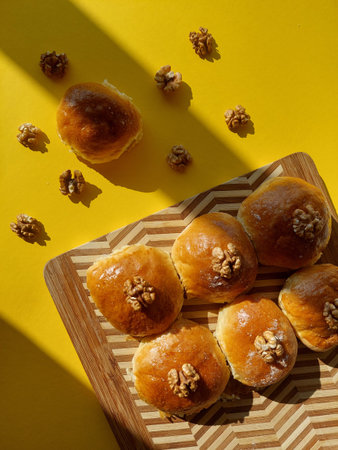 Homemade Sweet Buns with Walnuts on a Wooden Board