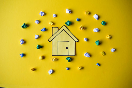 A Paper House on a Yellow Backgroundの写真素材