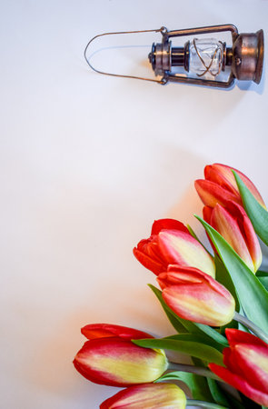 Vintage Miniature Lantern with Red and Yellow Tulipsの写真素材