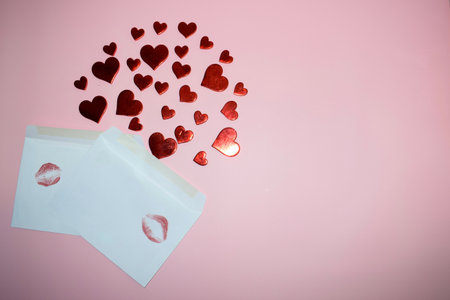 valentine's day concept with hearts and envelope on pink backgroundの写真素材
