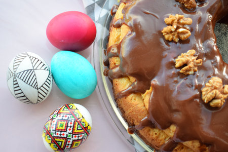 Easter cake with chocolate glaze and eggs on a white background