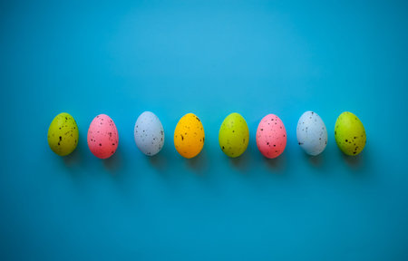 Colorful easter eggs on blue background. Minimal easter concept.