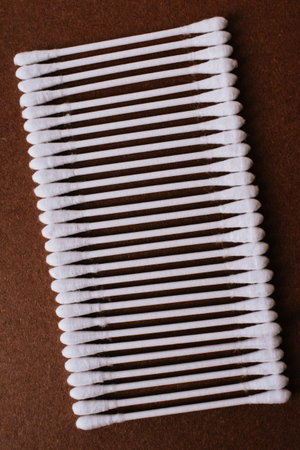 Cotton swabs on a brown background. Close-up.