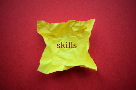 Yellow crumpled paper with the word SKILLS on it