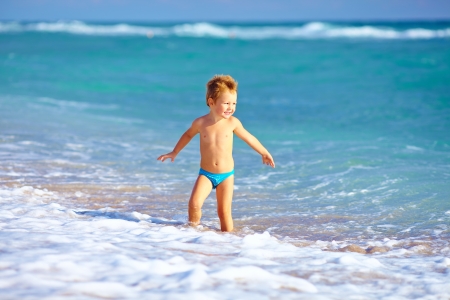 cute kid boy having fun in sea surfの写真素材