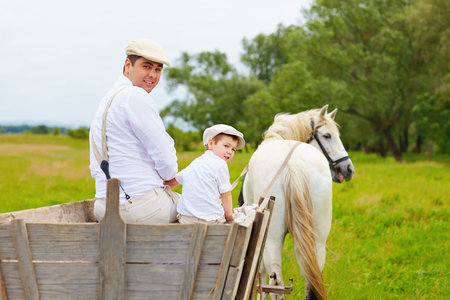 funny photo of farmer family and horse looking backの写真素材