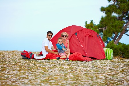 happy family camping in mountainsの写真素材