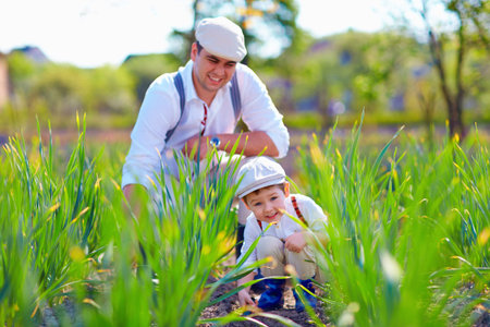 family weeds the garden bedsの写真素材