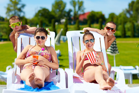 group of teenage kids enjoying summer in water parkの写真素材