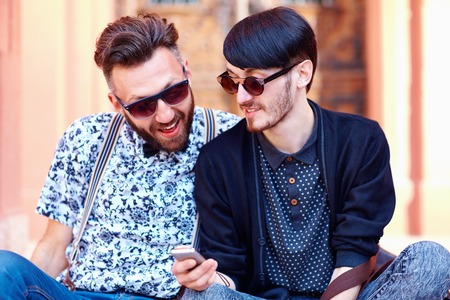 smiling friends chatting in social networkの写真素材
