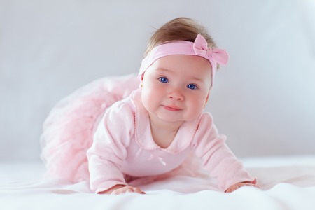 pretty baby girl in pink dressの写真素材