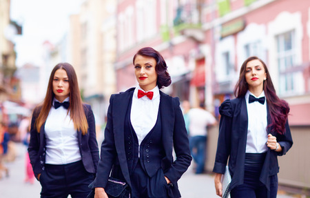 gorgeous women in black walking the city streetの写真素材