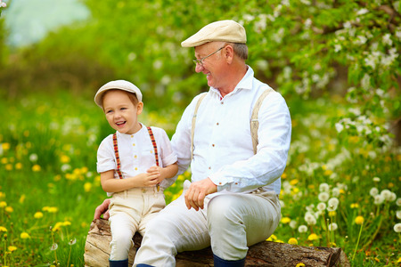 happy grandfather and grandson playing in spring gardenの写真素材