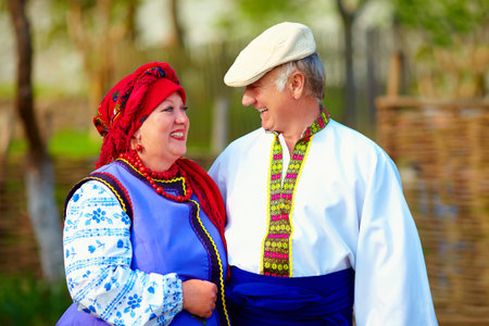 happy mature couple in traditional ukrainian clothes